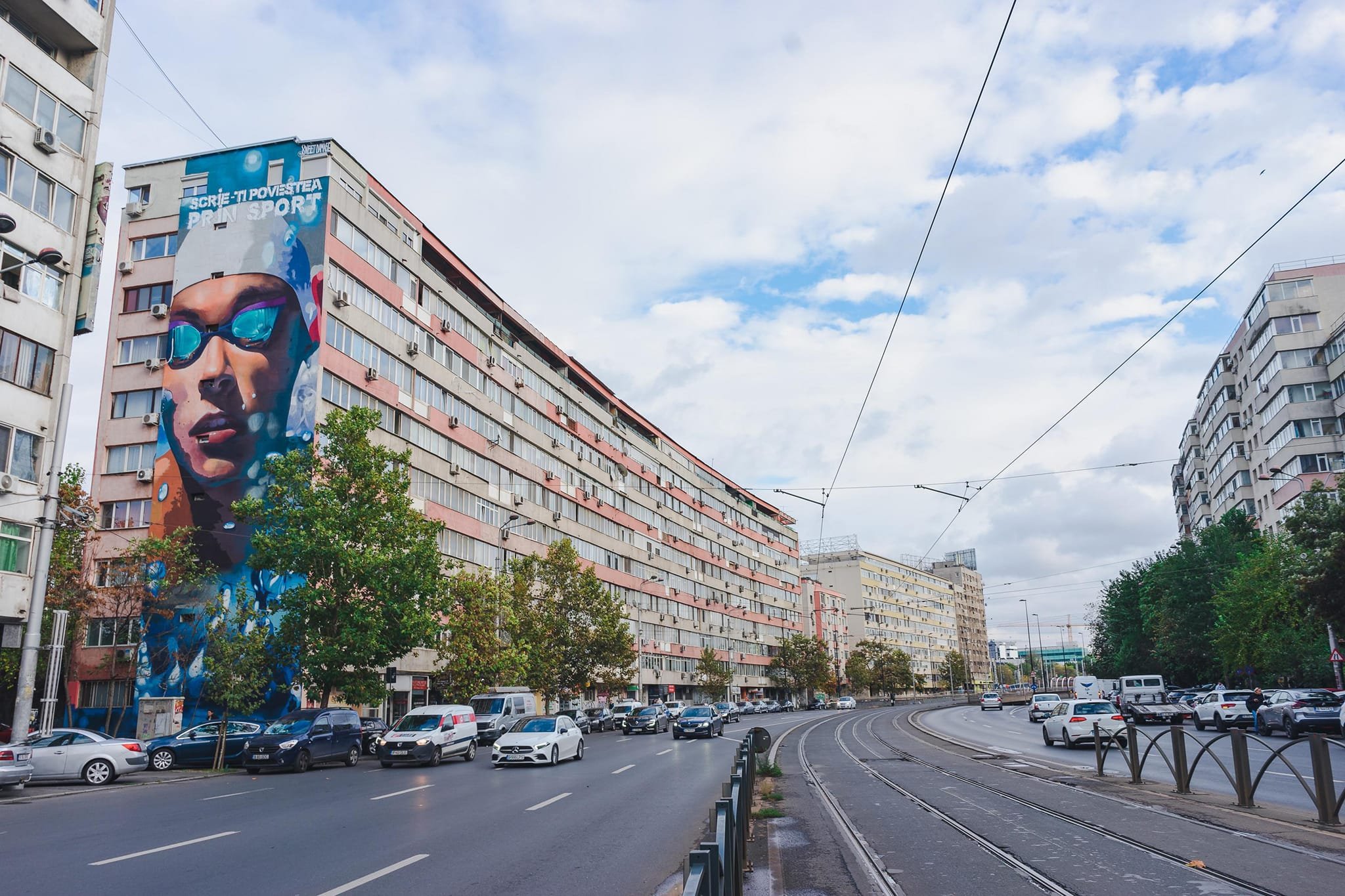 Pictură uriașă cu David Popovici pe un bloc din București. Reacția campionului - FOTO